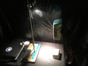 A handheld spectrometer to measure reflected light from a rock sample.