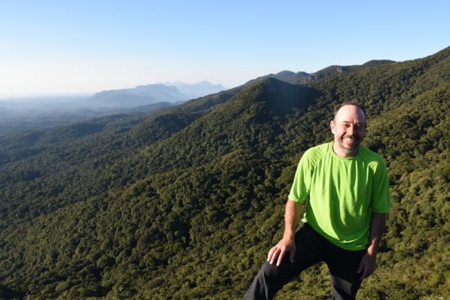 Dr. Guilherme Gualda overlooking a series of mountains in Brazil (2019).