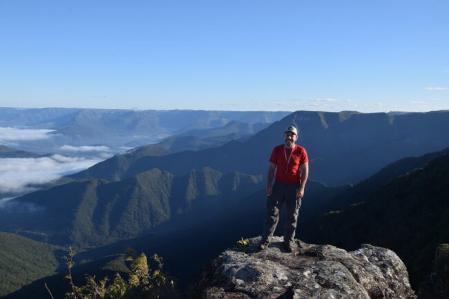 Dr. Guilherme Gualda overlooking a series of mountains in Brazil (2018).