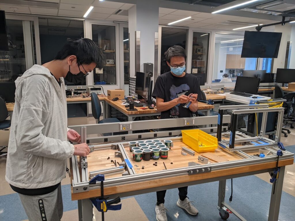 Yizhou and Leo assembling the base to mount the da Vinci Research Kit