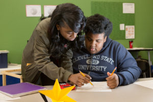 A student shows a classmate how to complete a challenging math problem. Photo by Allison Shelley/The Verbatim Agency for American Education: Images of Teachers and Students in Action