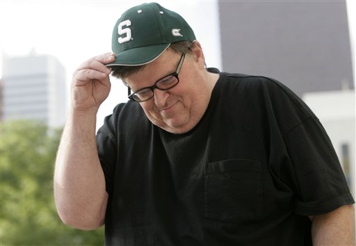 Award-winning documentary filmmaker Michael Moore adjusts his hat after addressing a crowd of supporters on the west steps of the State Capitol in downtown Denver on Sunday, June 24, 2007. Moore was on hand to promote his latest film on the status of the health care industry in the United States, which opens across the country in the week ahead. (AP Photo/David Zalubowski)