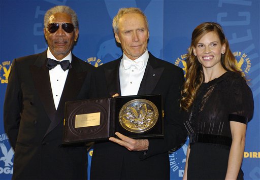 Actor and director Clint Eastwood, center, holds his nominees' plaque for outstanding directorial achievement in feature film for his work in "Million Dollar Baby," with cast members from the film Morgan Freeman, left, and Hilary Swank at the 57th Annual Directors Guild Awards in Beverly Hills, Calif., Saturday, Jan. 29, 2005. (AP Photo/Chris Pizzello)